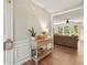 Bright entryway featuring wood floors, a decorative table, and a glimpse into the living room with large windows at 327 Balaban Cir, Woodstock, GA 30188