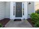 Close-up of a front door with decorative wreath and house number, framed by white trim and sidelights at 327 Balaban Cir, Woodstock, GA 30188