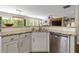 Open concept kitchen features granite countertops, stainless steel appliances and a view to the main living area at 327 Balaban Cir, Woodstock, GA 30188