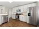 Bright, white kitchen with stainless steel appliances, granite countertops, and subway tile backsplash at 327 Balaban Cir, Woodstock, GA 30188
