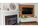 Cozy living room featuring a fireplace, wooden wall, and a decorative display cabinet, perfect for relaxation at 327 Balaban Cir, Woodstock, GA 30188