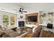 Cozy living room with a fireplace, custom built-ins, a work space, and large windows for natural light at 327 Balaban Cir, Woodstock, GA 30188