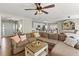 Bright living room with a comfortable sectional sofa, a ceiling fan, and an open view to the kitchen at 327 Balaban Cir, Woodstock, GA 30188