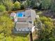 Aerial view capturing the home's backyard pool and lush surrounding greenery at 4395 Woodland Brook Se Dr, Atlanta, GA 30339