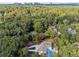 Expansive aerial view of a beautiful home, surrounded by lush trees with city skyline in the background at 4395 Woodland Brook Se Dr, Atlanta, GA 30339