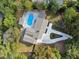 Aerial top-down view of the house showing off the swimming pool, patio and driveway at 4395 Woodland Brook Se Dr, Atlanta, GA 30339