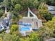 Aerial view of home featuring backyard pool, spacious driveway, and wooden pergola at 4395 Woodland Brook Se Dr, Atlanta, GA 30339