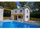 Pool and yard are defined by landscaping and hardscaping elements like a pergola at 4395 Woodland Brook Se Dr, Atlanta, GA 30339