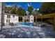 Landscaped backyard featuring a pool, hot tub, lounge chairs, and wooden pergola at 4395 Woodland Brook Se Dr, Atlanta, GA 30339
