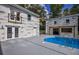Pool with connecting spa, modern brickwork, wooden pergola, and patio area at 4395 Woodland Brook Se Dr, Atlanta, GA 30339