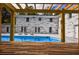 Backyard with a swimming pool featuring a modern white brick home and a wooden pergola at 4395 Woodland Brook Se Dr, Atlanta, GA 30339