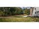 Lush backyard with mature trees and a brick house at 4395 Woodland Brook Se Dr, Atlanta, GA 30339