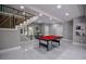 Finished basement with modern staircase and a pool table, ideal for recreation and entertaining guests at 4395 Woodland Brook Se Dr, Atlanta, GA 30339