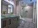 Bathroom with a modern double vanity and glass-enclosed shower with white marble at 4395 Woodland Brook Se Dr, Atlanta, GA 30339