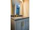 Elegant bathroom with a gray vanity, gold fixtures, and a stylish, modern design at 4395 Woodland Brook Se Dr, Atlanta, GA 30339