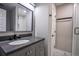 Modern bathroom with gray vanity, sleek black fixtures, and a beautifully tiled shower at 4395 Woodland Brook Se Dr, Atlanta, GA 30339