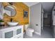 Charming bathroom featuring a modern vanity, unique wood accent wall, and glass-enclosed shower at 4395 Woodland Brook Se Dr, Atlanta, GA 30339