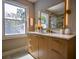 Bathroom vanity with window and backlit mirror; shower can be seen in the reflection at 4395 Woodland Brook Se Dr, Atlanta, GA 30339