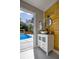 Chic bathroom featuring modern vanity with a vessel sink, wooden accent wall, and access to the pool area at 4395 Woodland Brook Se Dr, Atlanta, GA 30339