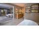 Bathroom featuring a double vanity with a soaking tub partially visible; primary bedroom in background at 4395 Woodland Brook Se Dr, Atlanta, GA 30339