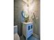 Elegant powder room featuring modern vanity, decorative lighting, and stylish fixtures and finishes at 4395 Woodland Brook Se Dr, Atlanta, GA 30339
