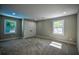 Well-lit bedroom with two large windows, plush carpet, and a closet at 4395 Woodland Brook Se Dr, Atlanta, GA 30339