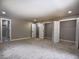 Bedroom with neutral carpet and paint, featuring multiple closets and access to ensuite bathroom at 4395 Woodland Brook Se Dr, Atlanta, GA 30339