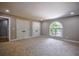 Bedroom featuring neutral walls and carpet, large arched window, and two closets at 4395 Woodland Brook Se Dr, Atlanta, GA 30339