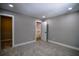 A spacious bedroom with neutral gray walls, plush carpet, and a closet door ajar at 4395 Woodland Brook Se Dr, Atlanta, GA 30339