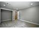 Large bedroom with gray walls, plush carpet, and an open closet door at 4395 Woodland Brook Se Dr, Atlanta, GA 30339