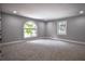 Bright and spacious bedroom features two large windows and neutral carpet at 4395 Woodland Brook Se Dr, Atlanta, GA 30339