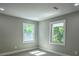 A cozy bedroom with two windows offering tree views and soft neutral carpeting at 4395 Woodland Brook Se Dr, Atlanta, GA 30339