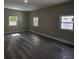 Spacious bonus room with three windows, wood floors, and neutral paint at 4395 Woodland Brook Se Dr, Atlanta, GA 30339