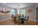 Bright dining room showcases modern chandelier, stylish decor, and natural light from large windows at 4395 Woodland Brook Se Dr, Atlanta, GA 30339