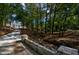 Curving driveway leading to an elegant home, surrounded by mature trees and natural landscaping at 4395 Woodland Brook Se Dr, Atlanta, GA 30339