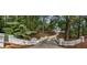 Long driveway leading to a beautiful home surrounded by lush greenery and mature trees at 4395 Woodland Brook Se Dr, Atlanta, GA 30339