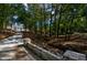 Driveway entrance with a charming bridge and wooded surroundings at 4395 Woodland Brook Se Dr, Atlanta, GA 30339