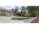 Landscaped driveway leading to an elegant brick home, surrounded by lush greenery and mature trees at 4395 Woodland Brook Se Dr, Atlanta, GA 30339