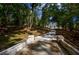 Scenic driveway winding through a wooded area, offering a glimpse of an elegant home at 4395 Woodland Brook Se Dr, Atlanta, GA 30339