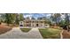 Wide angle view of an elegant home featuring a brick exterior, columns, and well-manicured lawn at 4395 Woodland Brook Se Dr, Atlanta, GA 30339