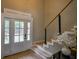 Bright foyer with staircase, double front doors, and modern design elements at 4395 Woodland Brook Se Dr, Atlanta, GA 30339