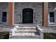 Elegant home entrance with brick steps and a classic black door at 4395 Woodland Brook Se Dr, Atlanta, GA 30339
