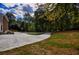 View of the driveway surrounded by a landscaped yard and trees and part of the home at 4395 Woodland Brook Se Dr, Atlanta, GA 30339