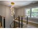Staircase featuring modern railing, hardwood stairs, stylish lighting, and view of the yard at 4395 Woodland Brook Se Dr, Atlanta, GA 30339