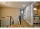 Hallway featuring hardwood floors, modern railing, and access to a stylish bathroom at 4395 Woodland Brook Se Dr, Atlanta, GA 30339