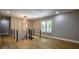 Upstairs hallway featuring modern railing, hardwood floors, stylish lighting, and a window view at 4395 Woodland Brook Se Dr, Atlanta, GA 30339