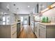 Stylish kitchen showcases white cabinets, stainless appliances, quartz counters, and modern lighting fixtures at 4395 Woodland Brook Se Dr, Atlanta, GA 30339