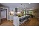 Open-concept kitchen flows into dining area, featuring a large island and stainless steel appliances at 4395 Woodland Brook Se Dr, Atlanta, GA 30339