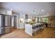 Modern kitchen boasts stainless steel appliances, white cabinetry, and an open layout with a dining area at 4395 Woodland Brook Se Dr, Atlanta, GA 30339