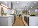 Modern kitchen with stainless steel appliances, quartz countertops, and an open layout to the dining area at 4395 Woodland Brook Se Dr, Atlanta, GA 30339